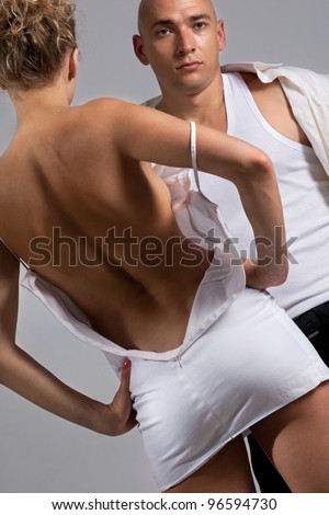 stock photo Emotional sexy scene woman undressing in front of man