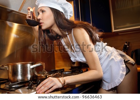 stock photo Portrait of sexy housewife chained by handcuffs to a pan