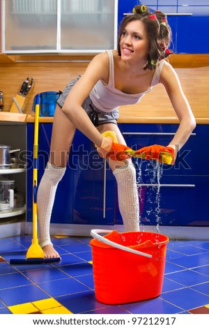 stock-photo-smiling-young-woman-squeezing-floor-cloth-and-cleaning-the-floor-at-home-97212917.jpg