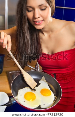 Young woman stand with scrambled eggs and pan with big smile