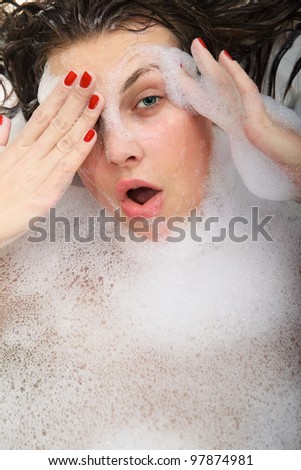 Portrait of young funny woman with soap foam