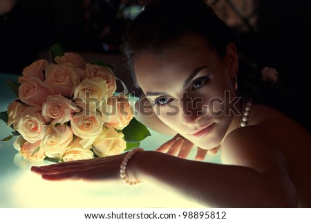Beautiful young bride sitting next to bar and groom