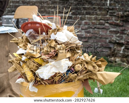 overfull food garbage can trash during a traditional village festival
