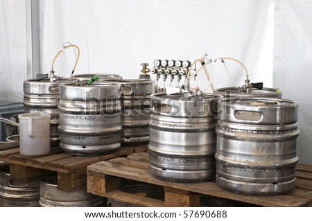 Steel industrial barrels of beer stocked in storage
