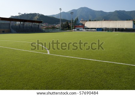 Little town soccer field stadium in plastic grass