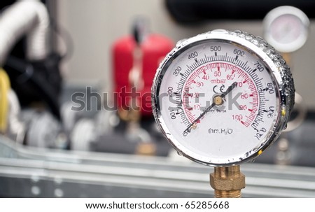 Industrial hydraulic round barometer with rain over it