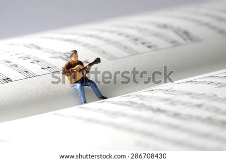 Miniature guitarist music book