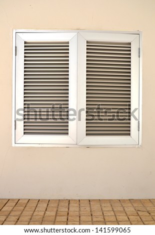 An industrial ventilation fan attached to a building