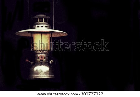 old storm lantern in the dark background vintage style