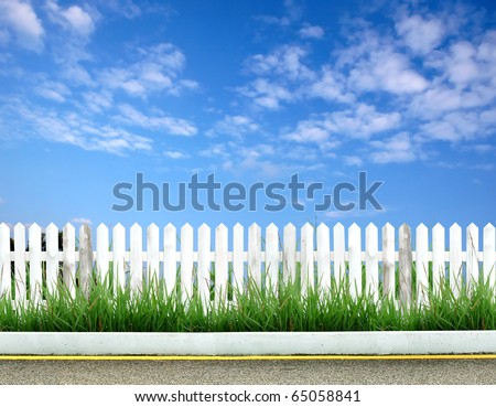 white fence with road and blue sky
