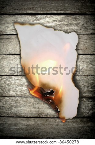 Burning paper on wooden wall