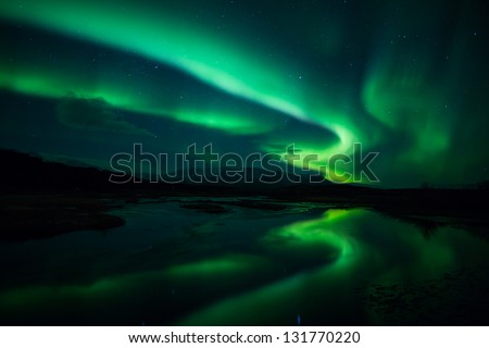 Northern Lights (Aurora Borealis) Reflection Across A Lake In Iceland