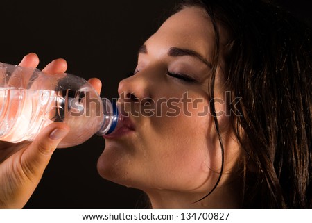 Hot Sports trainer female drinking water from bottle