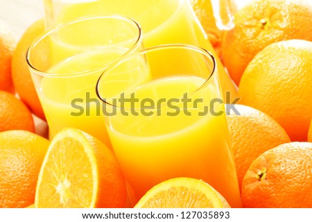 Composition with two glasses of orange juice and fruits