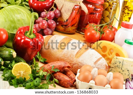 Assorted grocery products including vegetables fruits wine bread dairy and meat