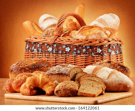 Wicker basket with bread and rolls Composition with bread and rolls. Baking products.