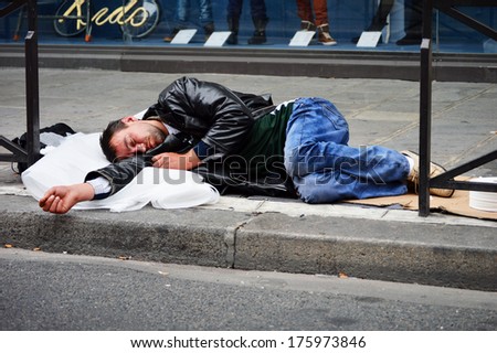 PARIS, FRANCE - SEPTEMBER 22: Man sleeping on the street in Paris on September 22, 2013. Homelessness in EU reached 3 million people in 2004. Globally about 100 million people live on the street.