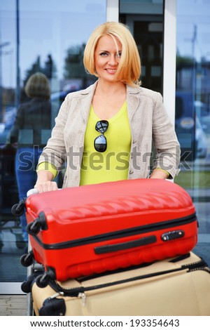 Young woman with luggage at the airport. Traveling tourist.