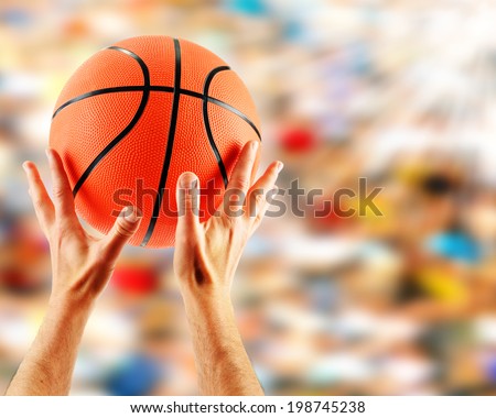 Hands catching basketball