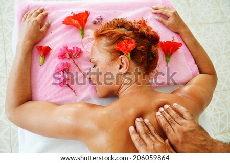 Beautiful young woman getting professional spa massage