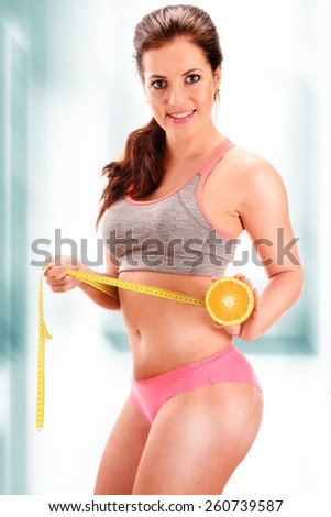 Young woman measuring herself. Weight loss.