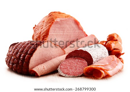 Assorted meat products including ham and sausages isolated on white