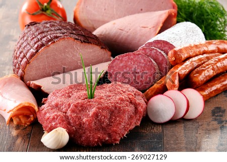 Assorted meat products including ham and sausages.