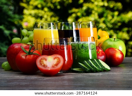Glasses with fresh organic detox juices in the garden