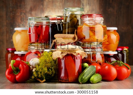 Jars with pickled vegetables and fruity compotes. Preserved food