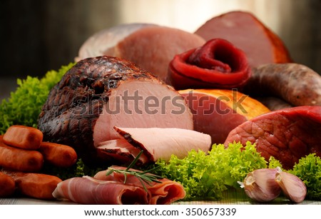 Assorted meat products including ham and sausages.