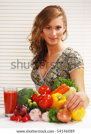 Beautiful young woman and vegetables on the table
