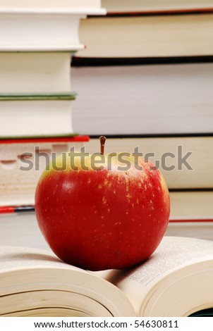 books on the table and apple