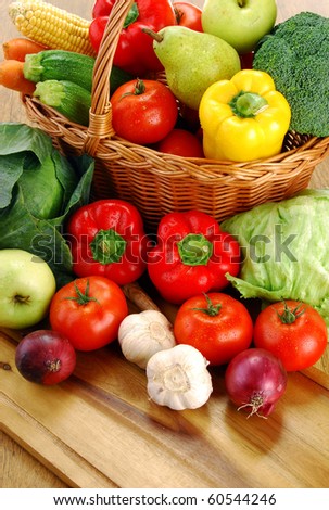 Composition with basket and vegetables on kitchen table
