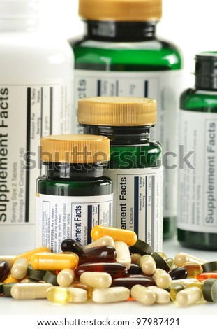 Composition with dietary supplement capsules and containers. Variety of drug pills