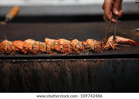 OLHAO, PORTUGAL - AUG 8:  Workers cooking seafood at seafood event on August 8, 2012 in Olhao, Portugal.