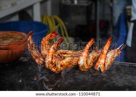 OLHAO, PORTUGAL - AUG 9: Workers cooking seafood at seafood event on August 9, 2012 in Olhao, Portugal.