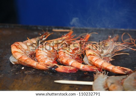OLHAO, PORTUGAL - AUG 11: Workers cooking seafood at seafood event on August 11, 2012 in Olhao, Portugal.
