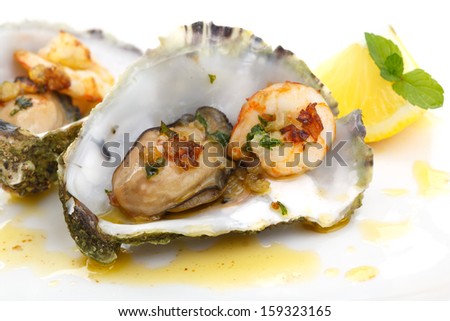 close up of fried oysters and shrimps in a shell isolated on white
