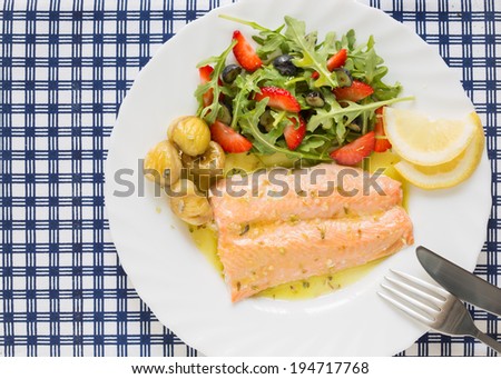 top view of roasted wild salmon fillet (low fat)  with berries salad