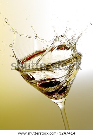 martini cocktail splashing on yellow background