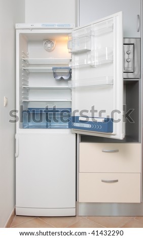 kitchen with a open refrigerator and microwave oven