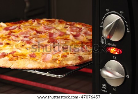 pizza being cooked  in oven - shallow DOF