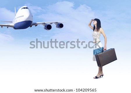 Young woman on the vintage baggage wait on the flying