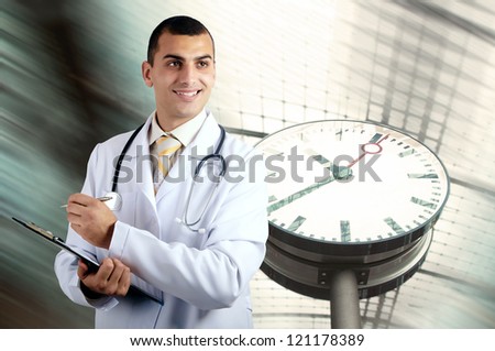 Smiling medical doctor with stethoscope on the hospitals background
