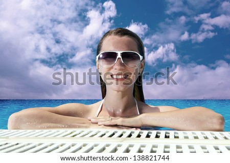 Beautiful happiness girl in white bikini stay in the waterpool