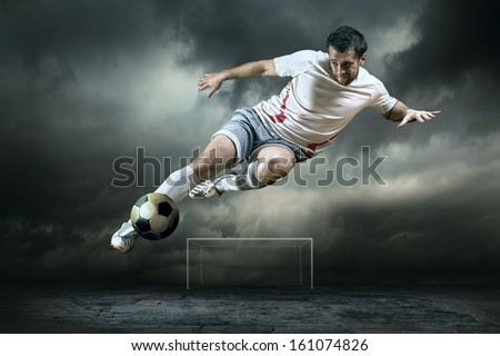 Football player with ball on field of stadium Football player with ball on field of stadium