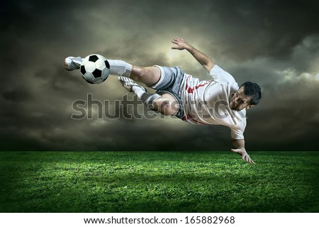 Football Player With Ball In Action Under Rain Outdoors
