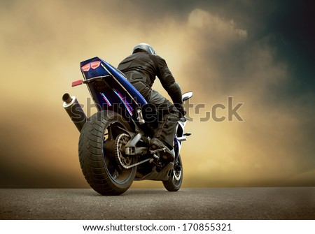 Man Seat On The Motorcycle Under Sky With Clouds