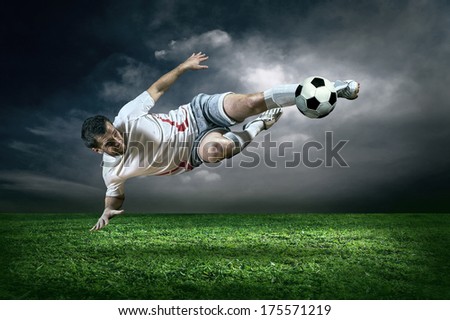 Football Player With Ball In Action Under Rain Outdoors