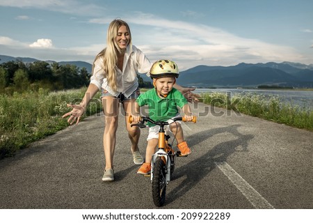 Happiness Mother and son on the bicycle outdoor